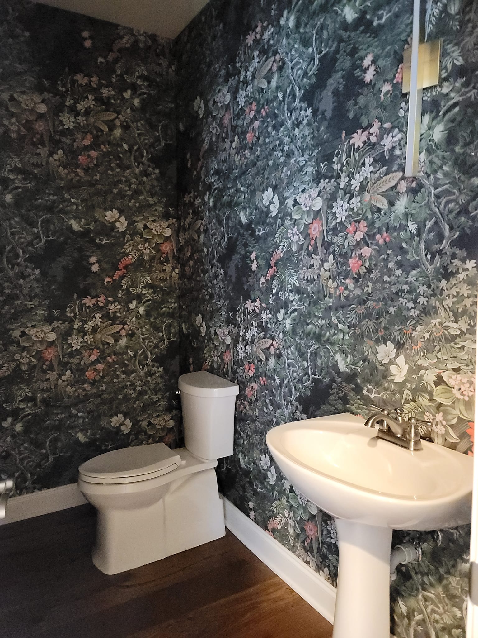 Dark botanical wallpaper in powder room by Lillian's Interiors