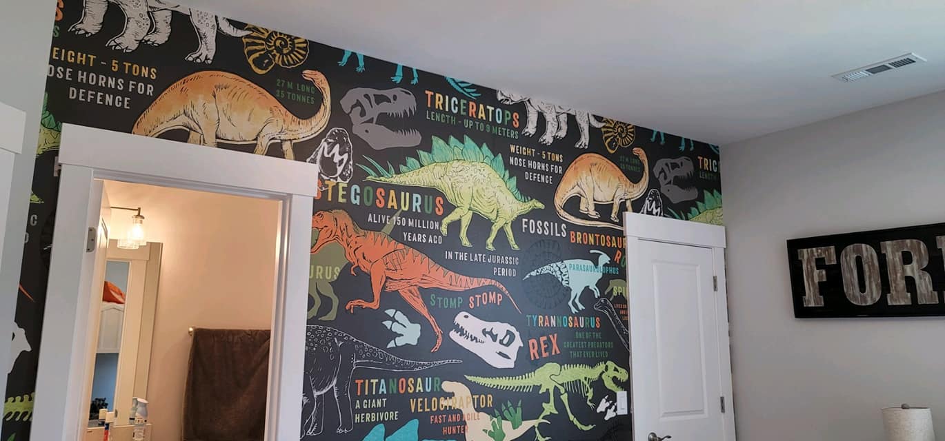 Colorful dinosaur wallpaper in children's room by Lillian's Interiors