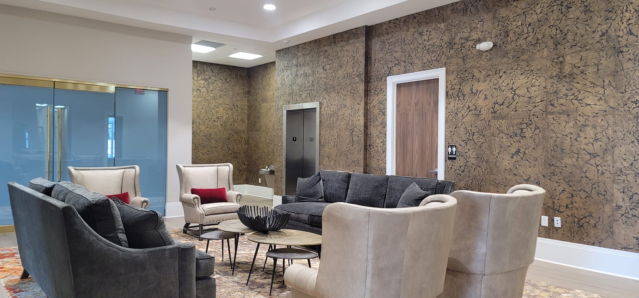 Commercial lobby with textured gold wallcovering by Lillian's Interiors