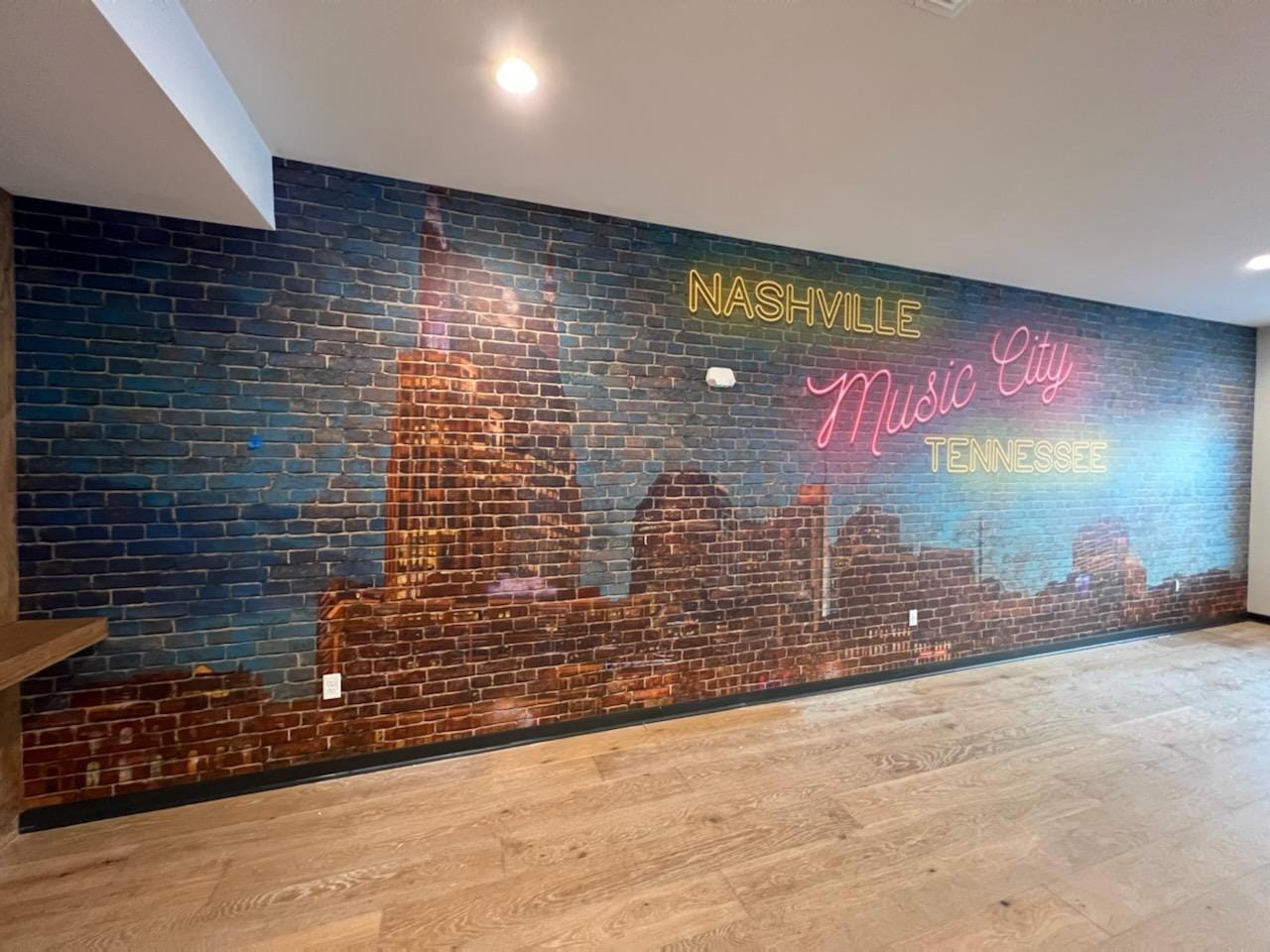 Nashville Music City neon mural on brick wall by Lillian's Interiors
