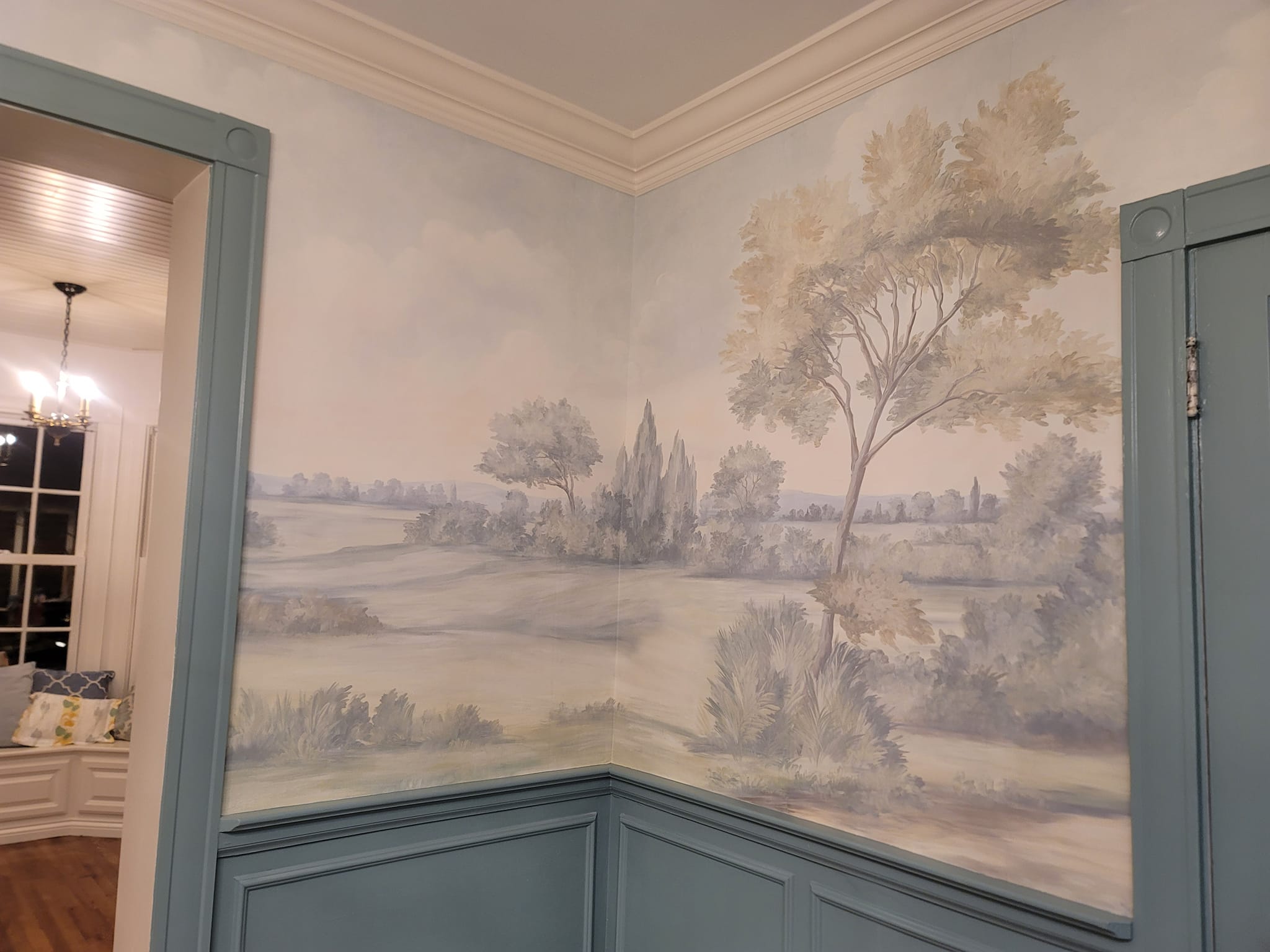 Scenic landscape mural with sage wainscoting by Lillian's Interiors